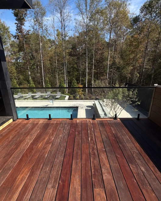 This patio deck is supported with laminated glass panels, spigot hardware, and a top rail for a seamless look and safety while grilling!
