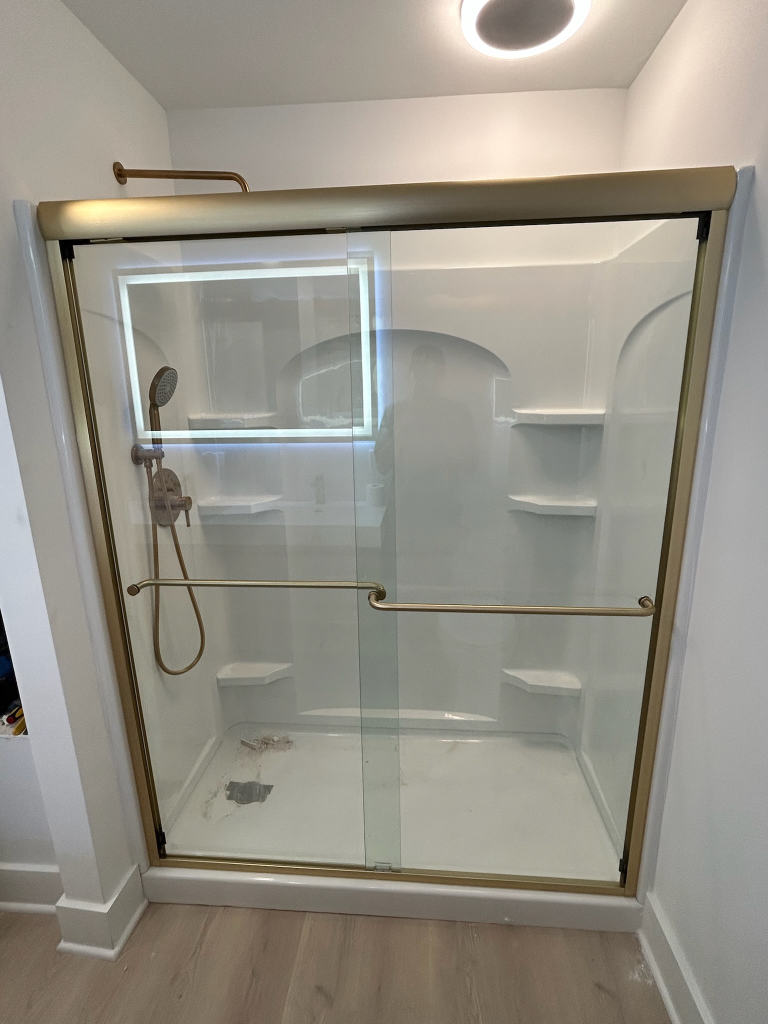 This is one of the only brushed gold semi-frameless sliding systems on the market, and we are thrilled with its performance!