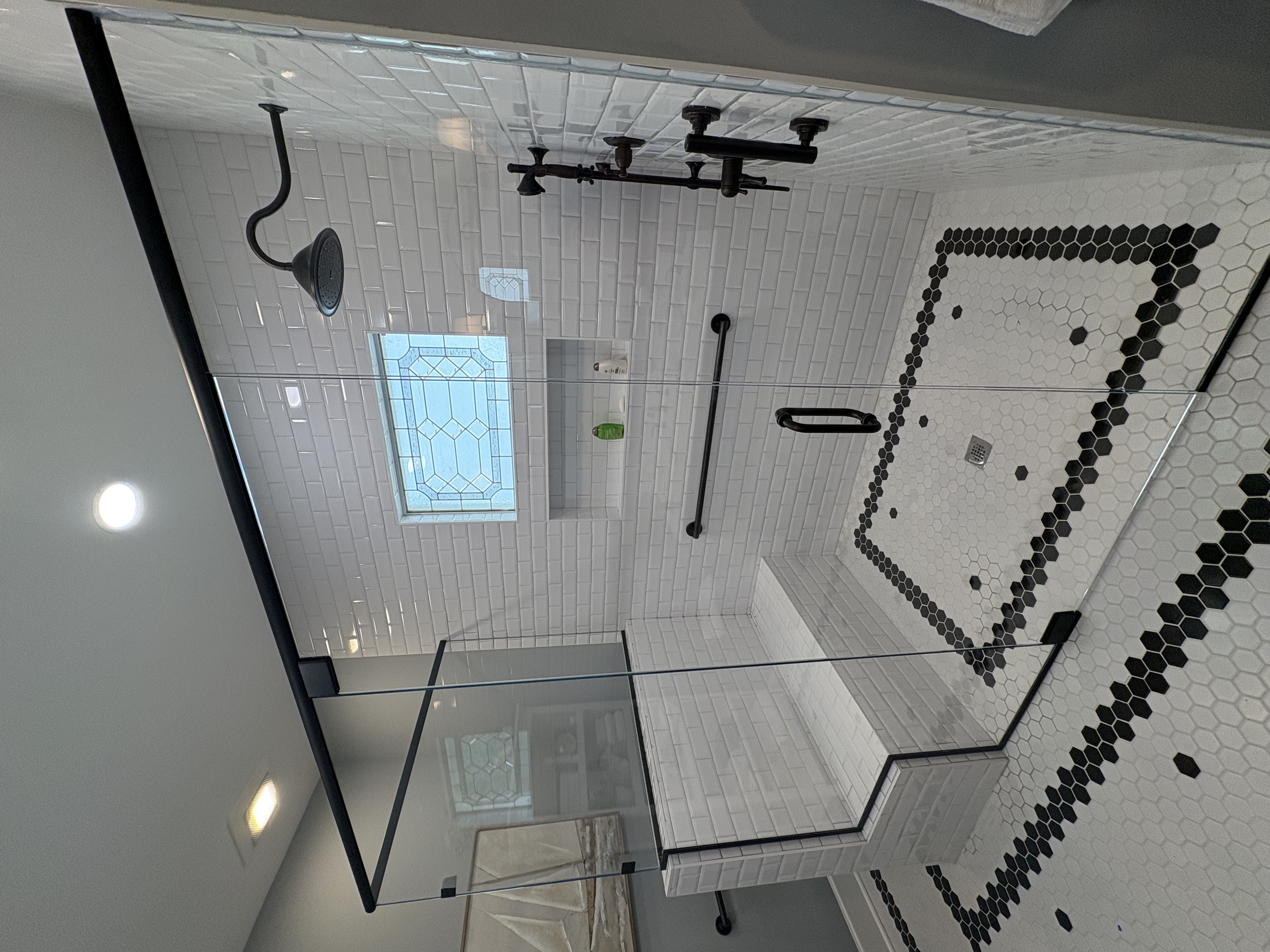 This is a custom double-notched corner shower with channel around the top and bottom of the panels for a slim frame look. Ask us how we can customize your shower with slim framing!