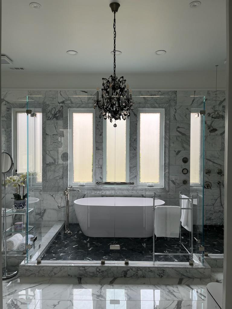 This is a 1/2" floating shower screen with low iron glass. Brad's clever design connects the two central panels with a solid Victorian style towel bar for additional structure. Both the left and right sides are open walk-ins!